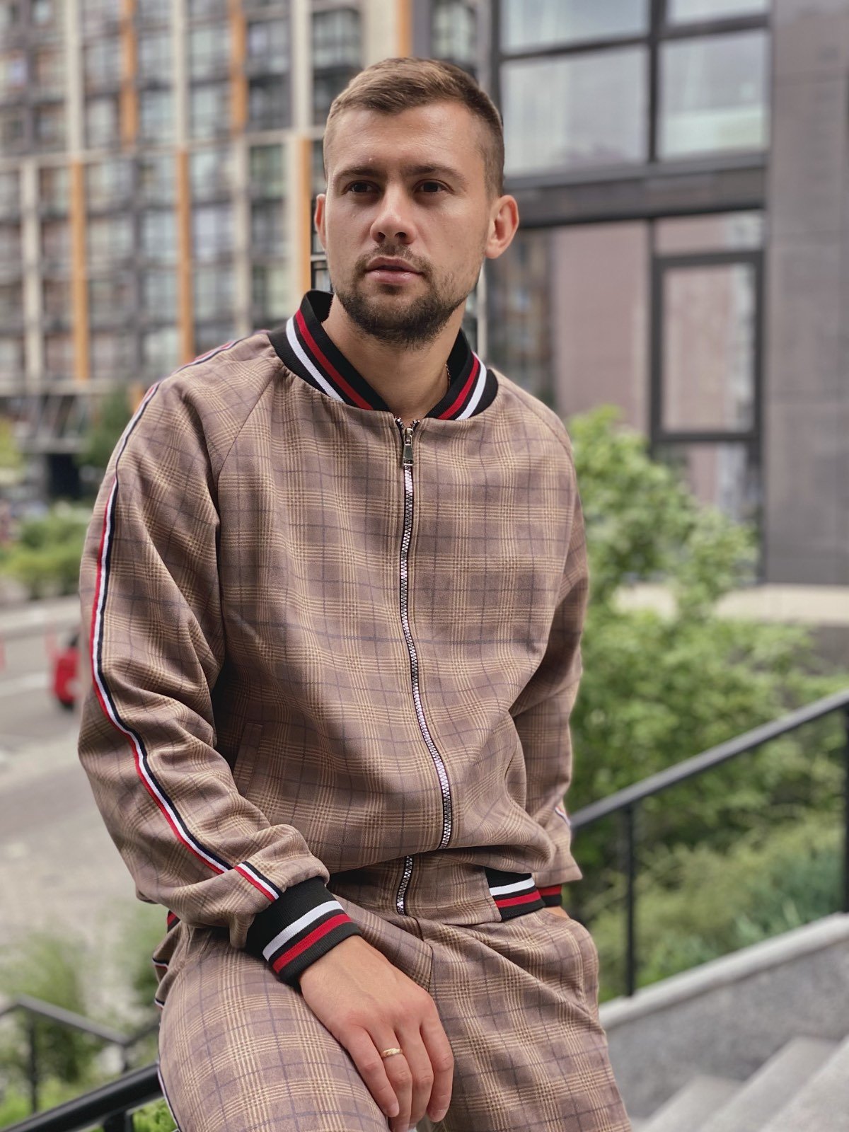 Man in a camel glen check Coach tracksuit