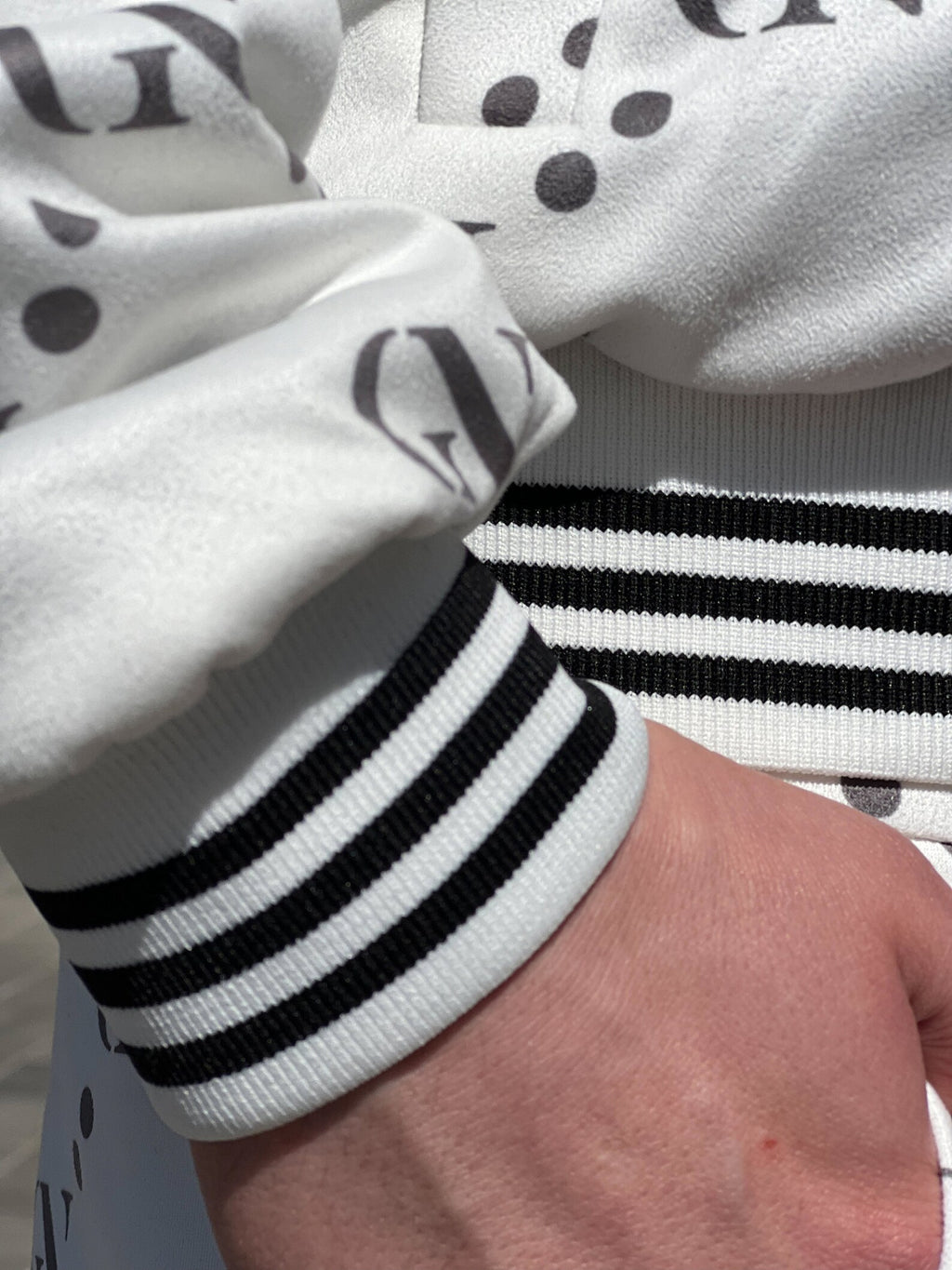 Pearl White Monogram Gentlemen Tracksuit — close-up of the ribbed cuff, another angle