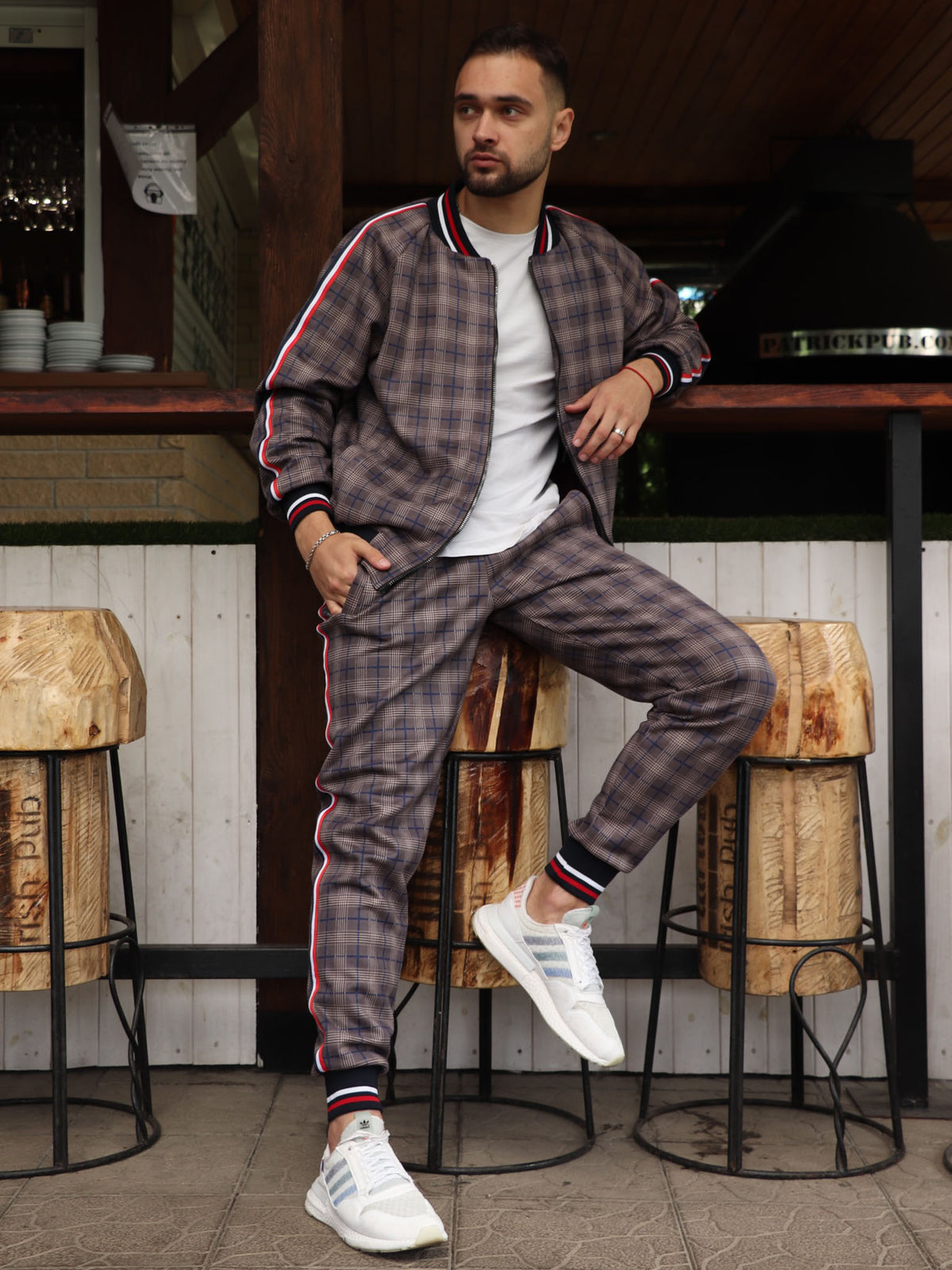 Brown & Grey Plaid Gentlemen Tracksuit — plaid bomber jacket and joggers, seated pose
