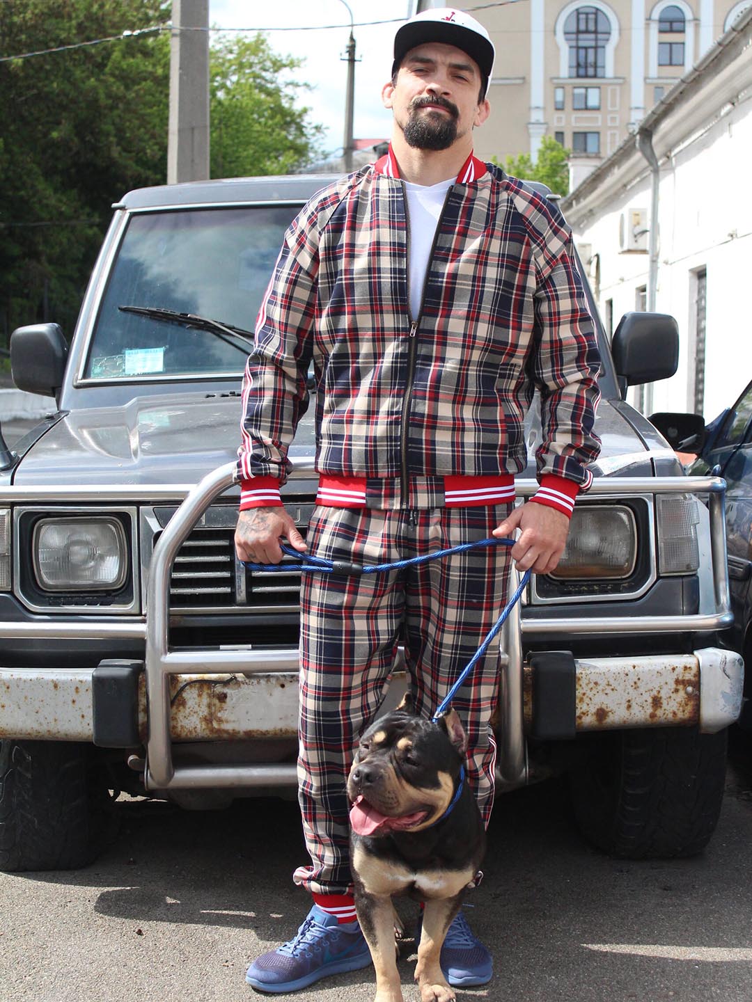 Premium Red & Beige Plaid Gentlemen Tracksuit — plaid bomber jacket and joggers, worn outdoors with a dog
