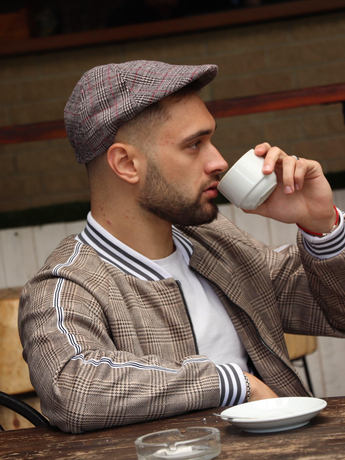 Brown Glen Plaid Flat Cap — glen plaid flat cap inspired by The Gentlemen, on the model, side view