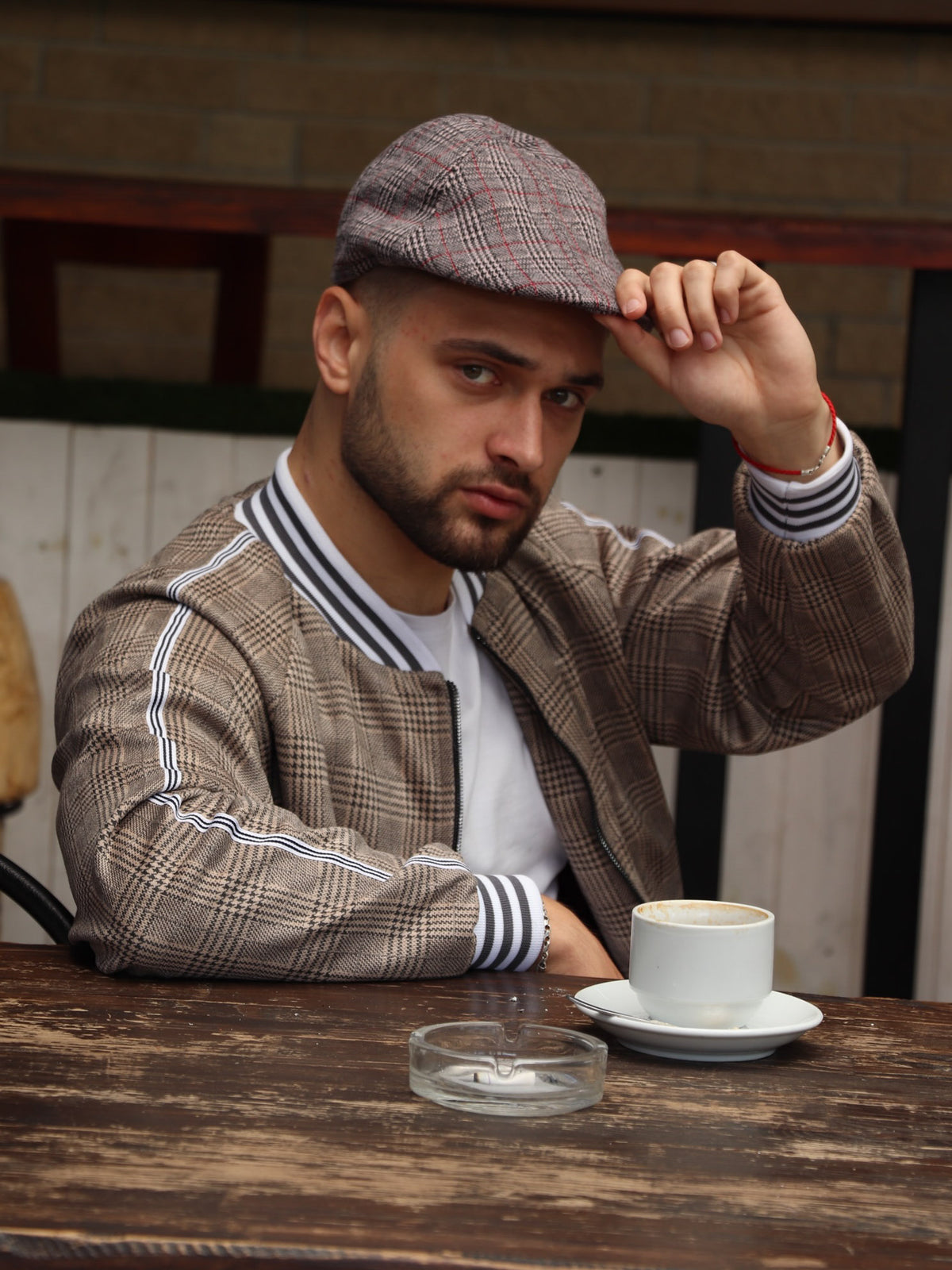 Brown Glen Plaid Flat Cap — on the model