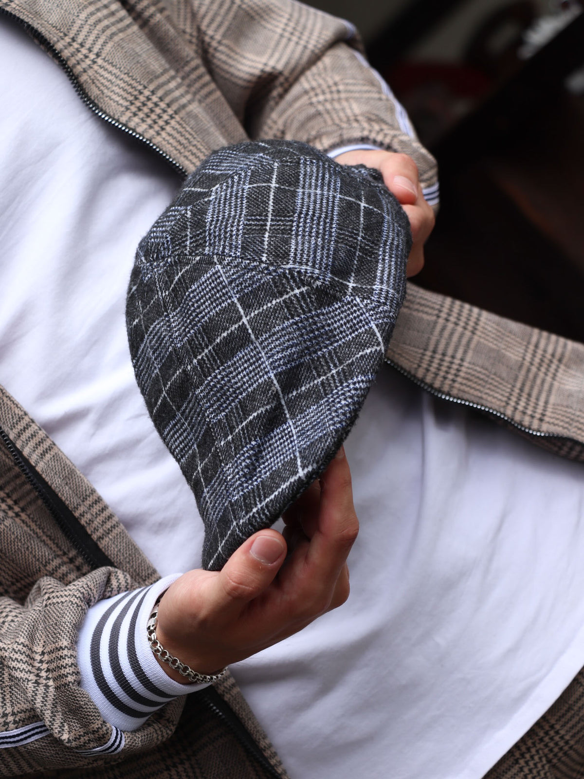 Navy Tartan Flat Cap — close-up of the cap in hand
