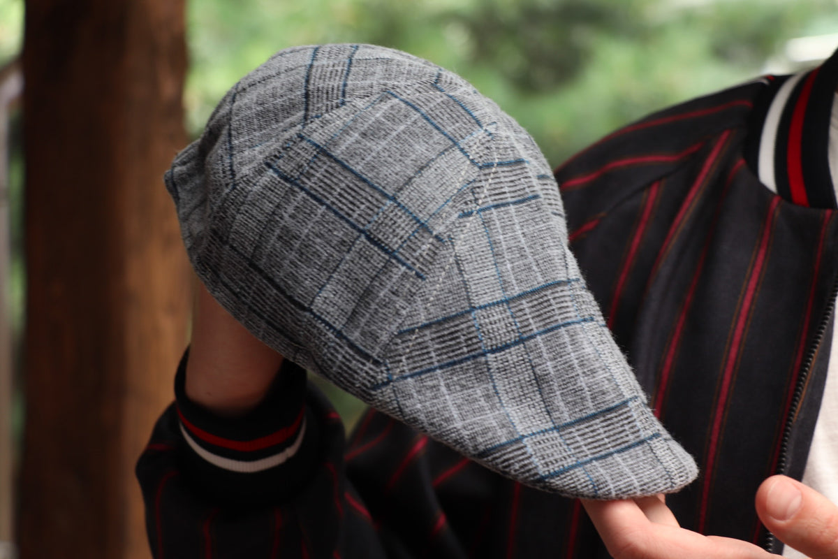 Blue Grey Plaid Flat Cap — close-up of the cap in hand
