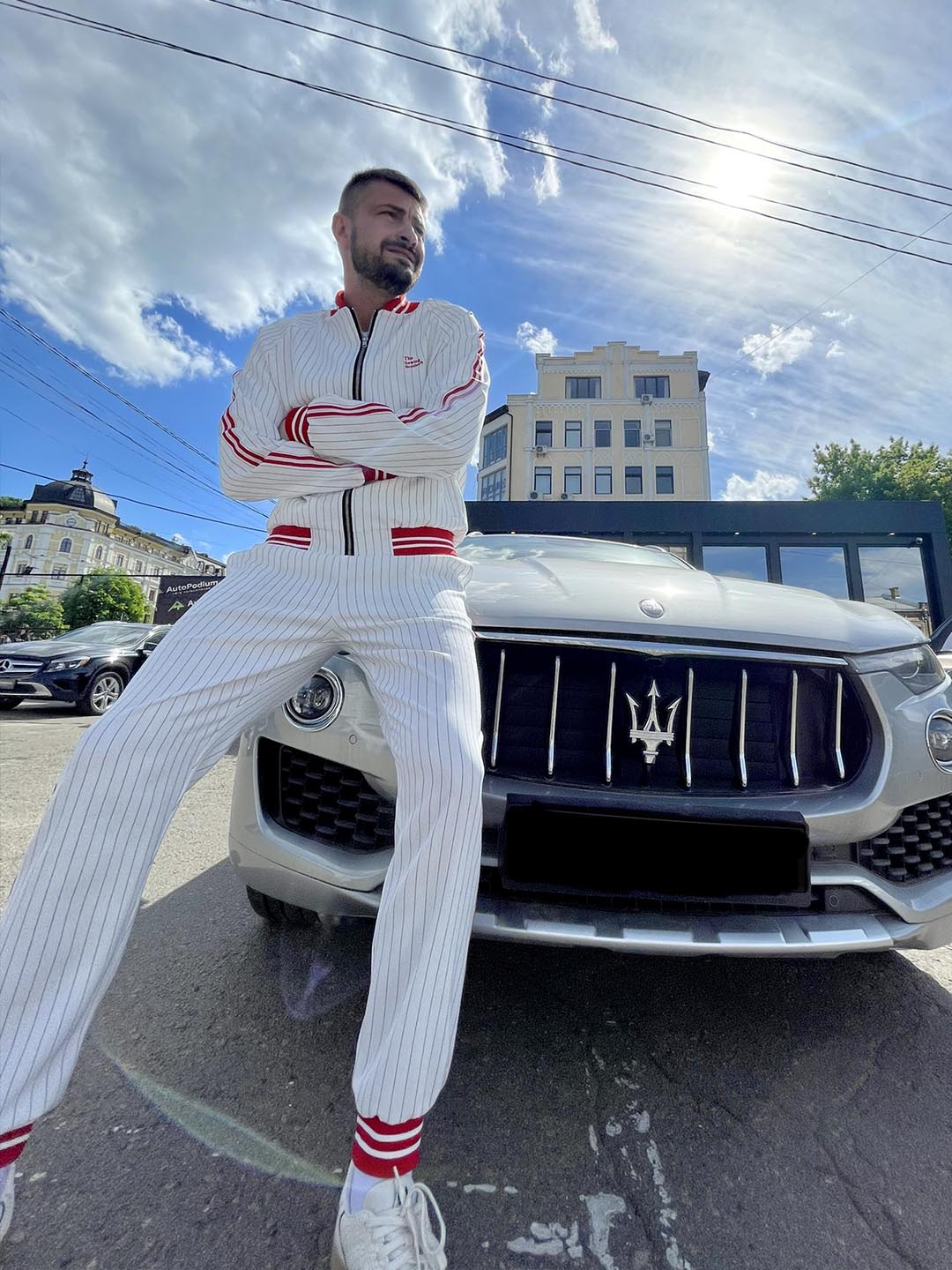 Premium White & Red Pinstripe Gentlemen Tracksuit — standing next to a car