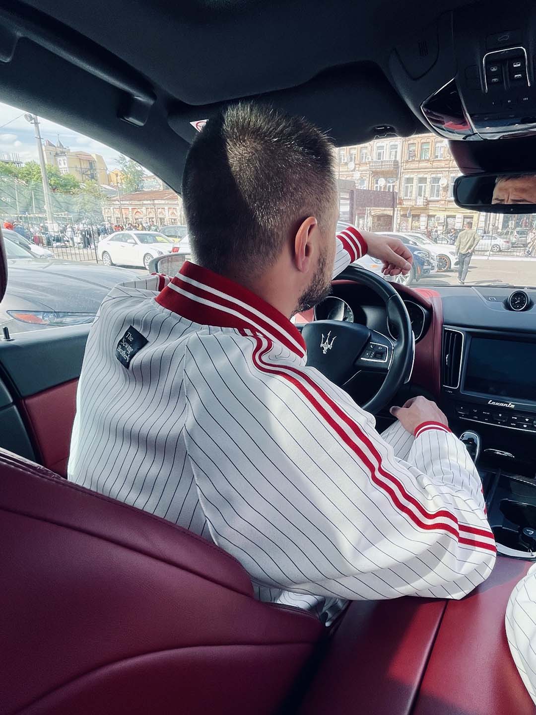 Premium White & Red Pinstripe Gentlemen Tracksuit — seated in a car, another angle