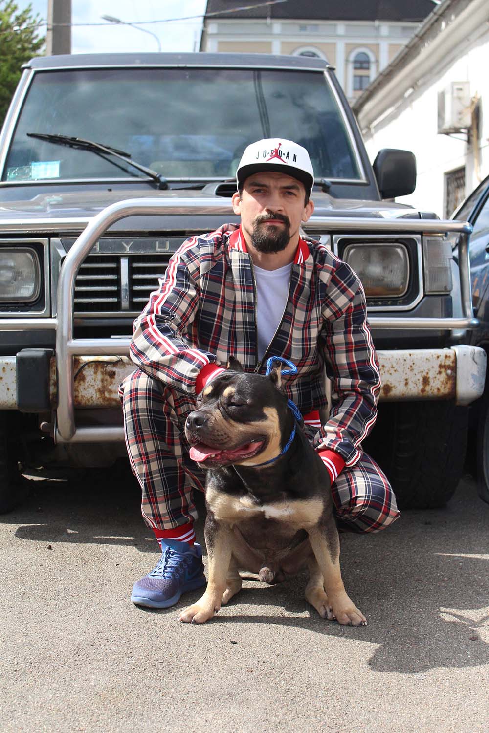Premium Red & Beige Plaid Gentlemen Tracksuit — crouching pose
