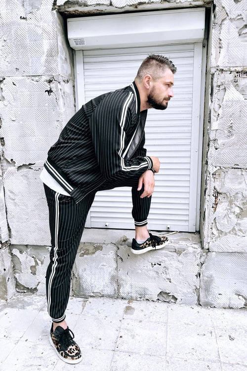 Premium Black Pinstripe Gangster Gentlemen Tracksuit — posed with one foot raised