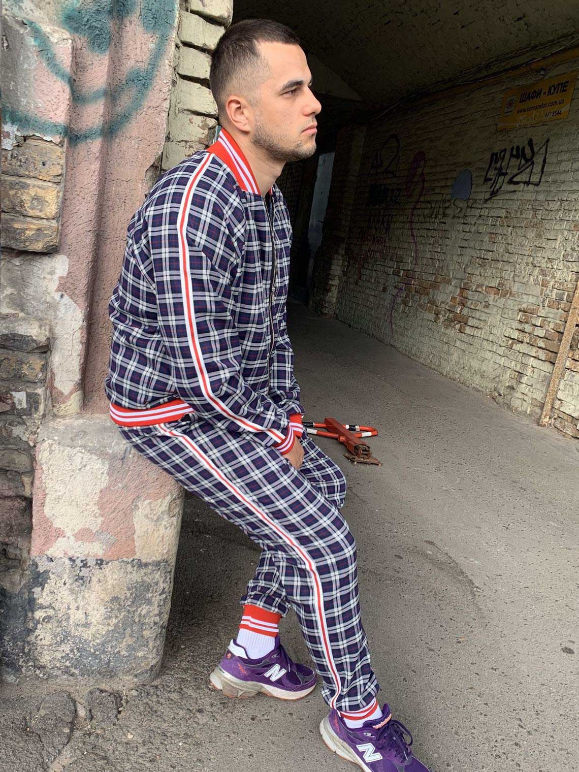 Premium Navy Check Gentlemen Tracksuit — seated pose, another angle