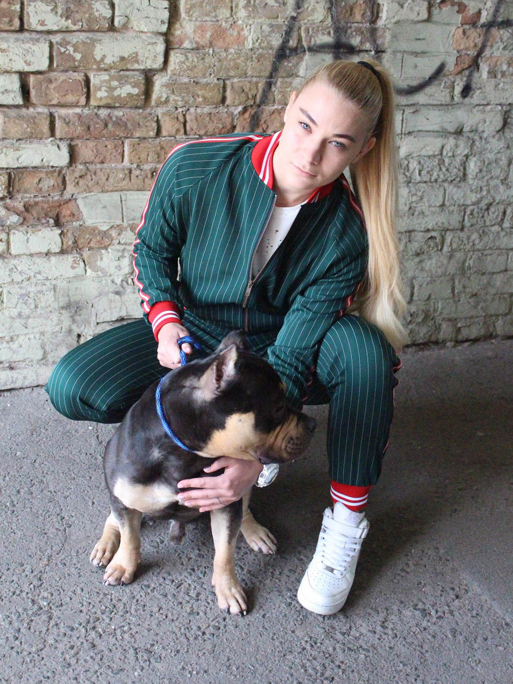 Premium Women's Green Pinstripe Tracksuit — worn outdoors with a dog