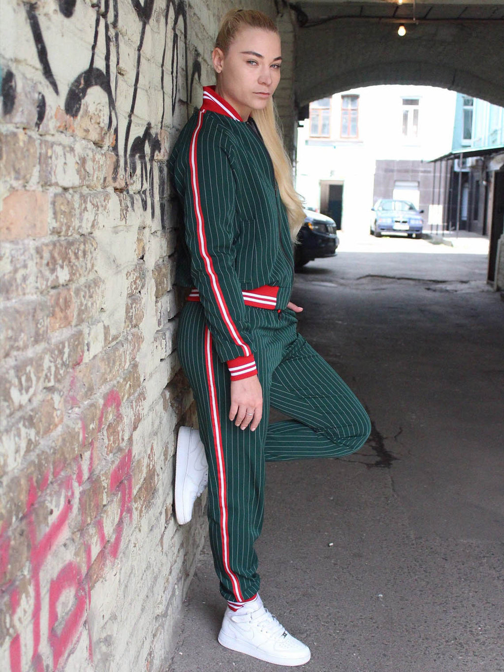 Premium Women's Green Pinstripe Tracksuit — leaning against a wall