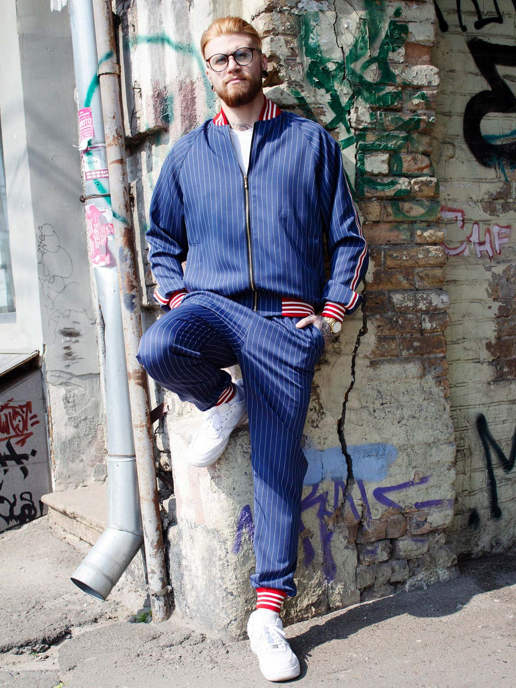 Premium Navy Blue Pinstripe Gentlemen Tracksuit — leaning against a wall