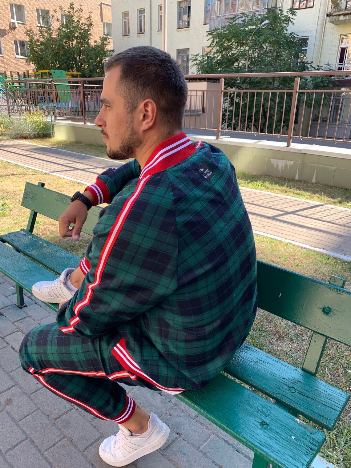 Premium Green Tartan Coach Gentlemen Tracksuit — seated pose, another angle