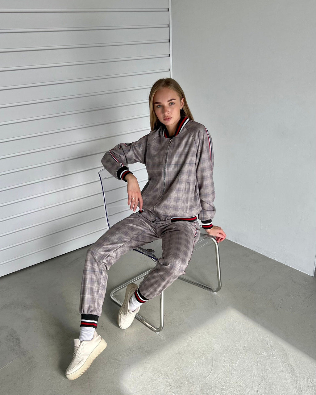 Women's Mauve Glen Plaid Tracksuit — glen plaid bomber jacket and joggers inspired by The Gentlemen, seated pose