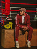 Premium Red Pinstripe Coach Gentlemen Tracksuit — pinstripe bomber jacket and joggers, seated pose