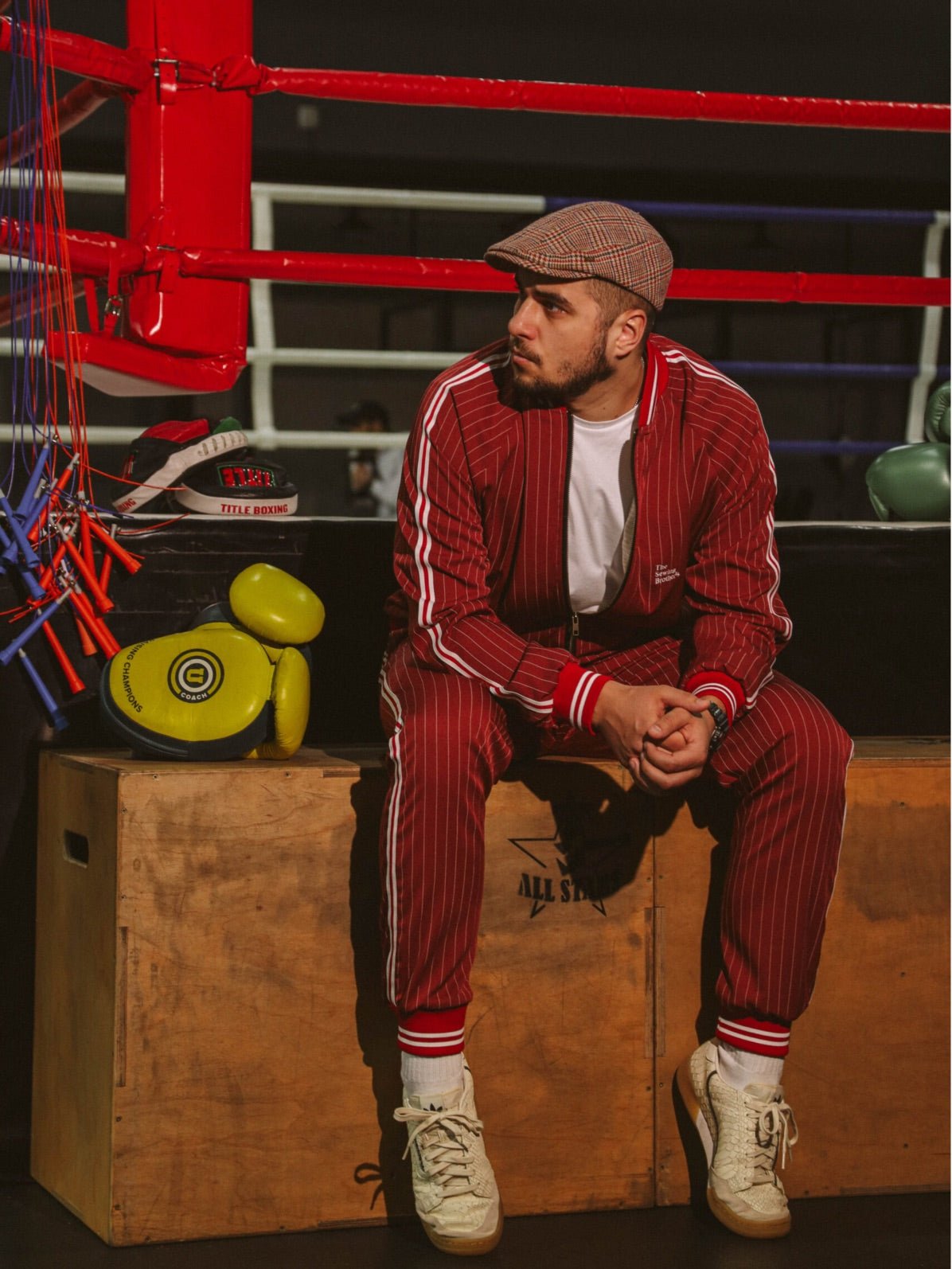 Premium Red Pinstripe Coach Gentlemen Tracksuit — pinstripe bomber jacket and joggers, seated pose