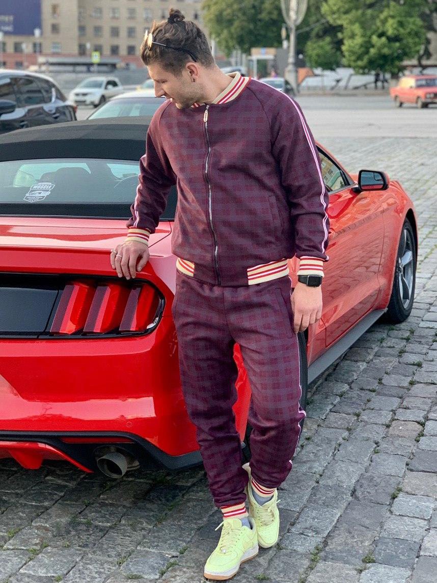 Burgundy Plaid Gentlemen Tracksuit — plaid bomber jacket and joggers, standing next to a car